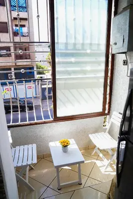 a room with a table and two chairs and a window at Peaceful Apartment with AC & fiber-speed internet in Casablanca