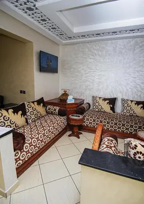a living room with couches and a table at Peaceful Apartment with AC & fiber-speed internet in Casablanca
