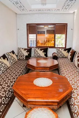 a living room with a couch and two tables at Peaceful Apartment with AC & fiber-speed internet in Casablanca