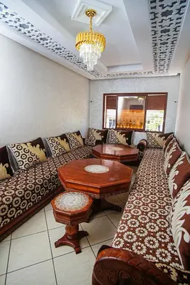 a living room with a couch and a table at Peaceful Apartment with AC & fiber-speed internet in Casablanca