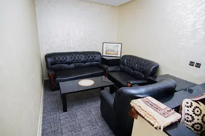 a waiting room with leather couches and a table at Peaceful Apartment with AC & fiber-speed internet in Casablanca