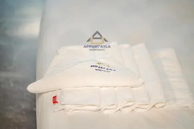 a pile of white towels sitting on a refrigerator at Bright Spacious Suite- By Appart'Ayla in Casablanca