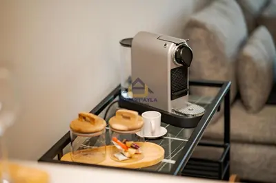 a table with a coffee maker and donuts on it at Bright Spacious Suite- By Appart'Ayla in Casablanca