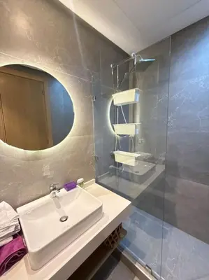 a bathroom with a sink and a mirror at Ideal home away from home in Maarif