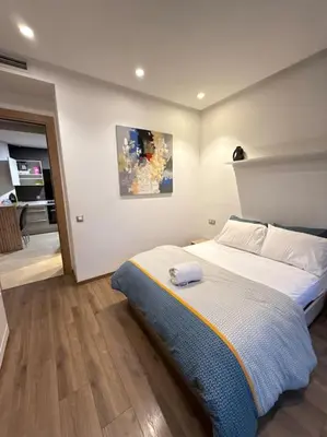 a bedroom with a bed and a painting on the wall at Ideal home away from home in Maarif