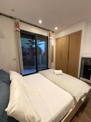 a bedroom with a large bed and a large window at Ideal home away from home in Maarif