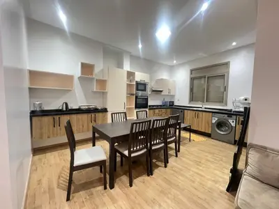 a kitchen and dining room with a table and chairs at Sweet appartement Boulevard de Paris à 2min du centre ville in Casablanca