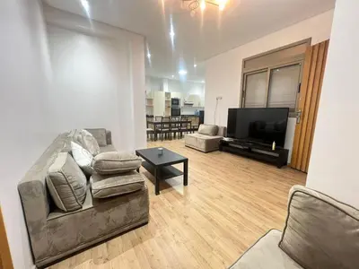 a living room with a couch and a table at Sweet appartement Boulevard de Paris à 2min du centre ville in Casablanca