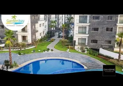 a large swimming pool in front of a building at Superbe Appartement pieds dans l'eau Résidence Garden Bay in Sidi Rahal
