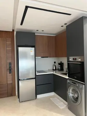 a kitchen with a refrigerator and a washing machine at Modern minimaliste retreat in Maarif in Casablanca