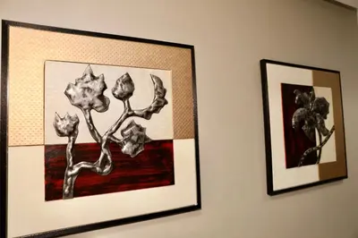 two pictures of flowers are hanging on a wall at Luxury apartment in Casablanca