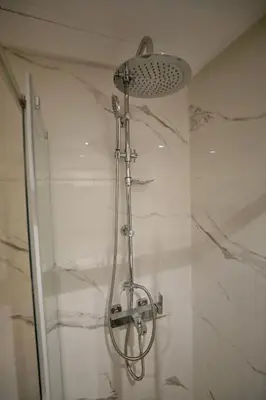 a shower with a shower head in a bathroom at 2 Luxury BD apartment Near of Rabat Agdal Station in Rabat