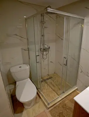 a bathroom with a toilet and a shower at 2 Luxury BD apartment Near of Rabat Agdal Station in Rabat