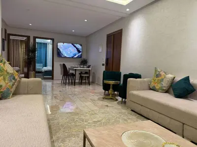 a living room with two couches and a dining room at 2 Luxury BD apartment Near of Rabat Agdal Station in Rabat