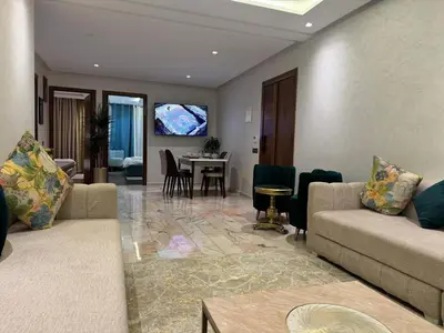 a living room with two couches and a dining room at 2 Luxury BD apartment Near of Rabat Agdal Station in Rabat