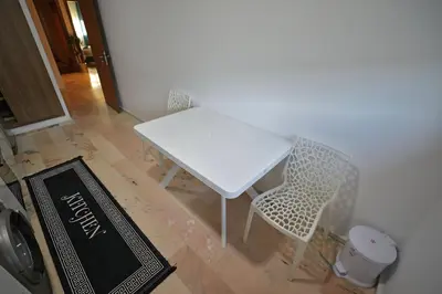 a white table and chairs in a room at 2 Luxury BD apartment Near of Rabat Agdal Station in Rabat