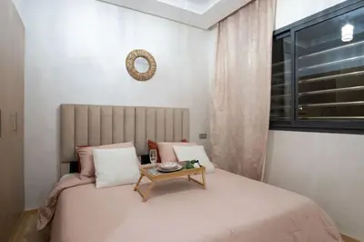 a bedroom with a bed with a table on it at Magnifique 2 chambres, vue panoramique et piscine in Casablanca