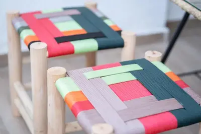 a group of colorful chairs sitting next to each other at Appartement avec Piscine Proche Plage in Bouznika