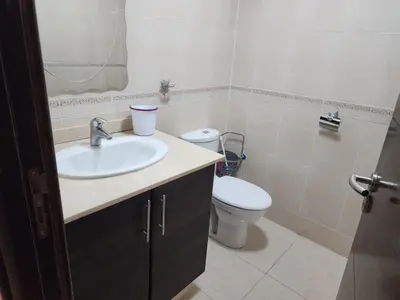 a bathroom with a sink and a toilet at Residence la corniche d in Mohammedia
