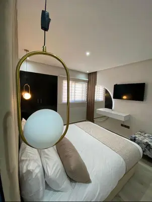 a bedroom with a bed with a round light on it at Apartement agdal in Rabat
