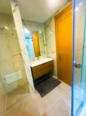 a bathroom with a tub and a sink and a shower at 3BD Appart à 2 min Gare Agdal Luxe & Confort in Rabat