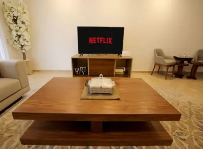 a living room with a tv and a coffee table at 3BD Appart à 2 min Gare Agdal Luxe & Confort in Rabat