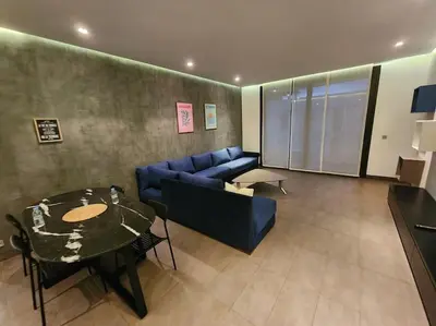 a living room with a blue couch and a table at Blue Anfa Place in Casablanca