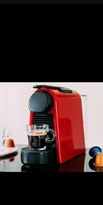 a red coffee maker sitting on top of a table at Appartement neuf tres calme balcon vue sur l'océan in Skhirat