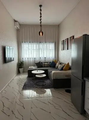 a living room with a couch and a table at Magnificent Cozy New Luxury Condo in Prime Casablanca Location in Les Camps