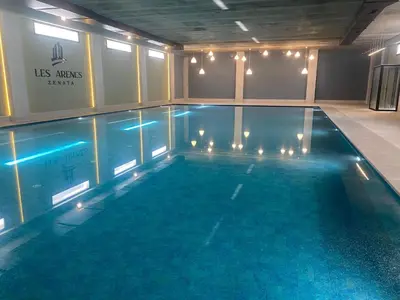 a large swimming pool with lights in a building at Luxury 3 Bedroom Apt Near Park and Sea, Heated Indoor Pool, Wifi, Free Parking in Casablanca