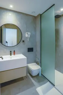 a bathroom with a sink and a toilet and a mirror at Résidence Luxuria - Rooftop Pool in Casablanca
