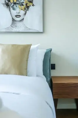 a bedroom with a bed and a picture on the wall at Résidence Luxuria - Rooftop Pool in Casablanca