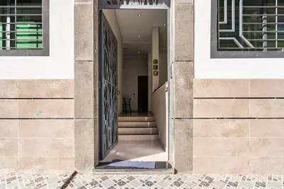 an open door of a building with a staircase at New appartement next to the beach Sidi Rahal in Sidi Rahal