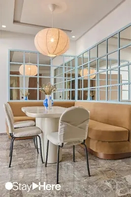a dining room with a table and chairs and a couch at StayHere Casablanca - Oasis - Premium Residence in Casablanca