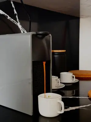 a coffee maker is pouring coffee into a cup at Sunset Lover in Casablanca-Port