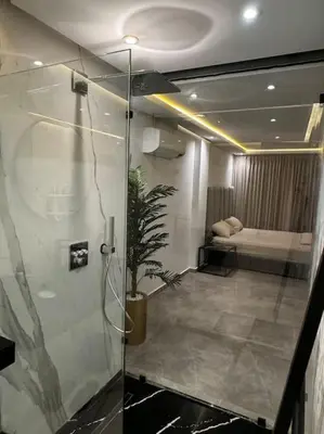 a bathroom with a shower and a bed in a room at Sunset Lover in Casablanca-Port