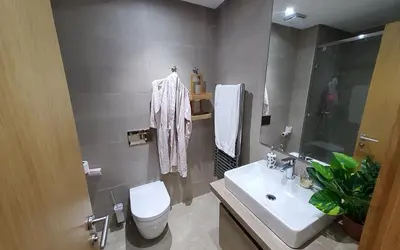 a bathroom with a white toilet and a sink at Appart chic vue Mer in Casablanca