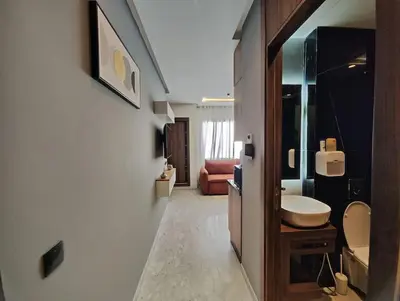 a bathroom with a sink and a toilet in a room at Studio Palmiers Maarif in Casablanca