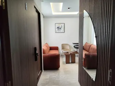 a living room with a couch and a chair at Studio Palmiers Maarif in Casablanca