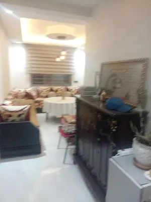 a living room with a couch and a table at Basatin al firdaws in Ben Yakhlef