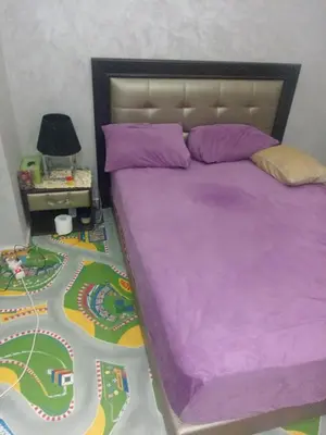 a bedroom with a bed with a toy track on the floor at Basatin al firdaws in Ben Yakhlef