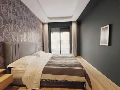 a bedroom with a large bed and a window at Résidence Acacias Casablanca in Casablanca