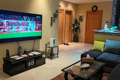 a living room with a flat screen tv and a couch at Suite Meublée à Nouaceur in Nouaceur