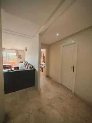 an empty living room with a couch and a door at Appartement au Bord de Mer in Casablanca