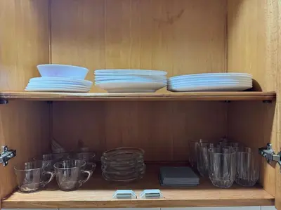 a wooden shelf with plates and bowls on it at Appartement moderne 2 chambres avec parking Agdal in Rabat