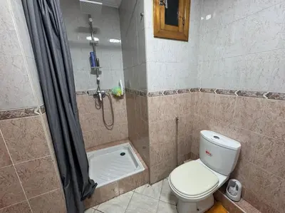 a bathroom with a shower and a toilet in it at Appartement moderne avec parking - Proche Mall in Rabat