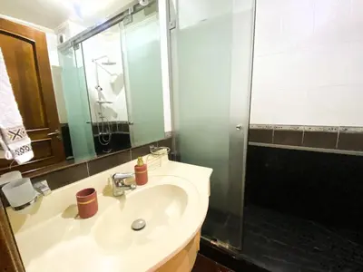 a bathroom with a sink and a shower at Cosy calm 2BDR central near train & tramway in Casablanca
