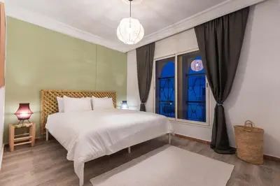 a bedroom with a white bed and a window at Stylish APPT 2 BDR Downtown of Rabat by MERAT HOME in Rabat