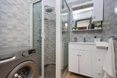 a bathroom with a washing machine and a sink at Stylish APPT 2 BDR Downtown of Rabat by MERAT HOME in Rabat