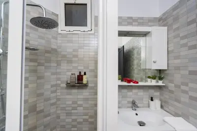 a bathroom with a sink and a mirror at Stylish APPT 2 BDR Downtown of Rabat by MERAT HOME in Rabat